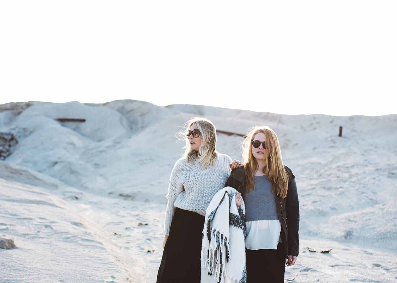 two women standing in the snow